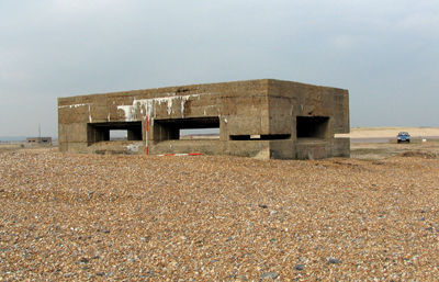 Pillbox under building recording on the beach at Pett